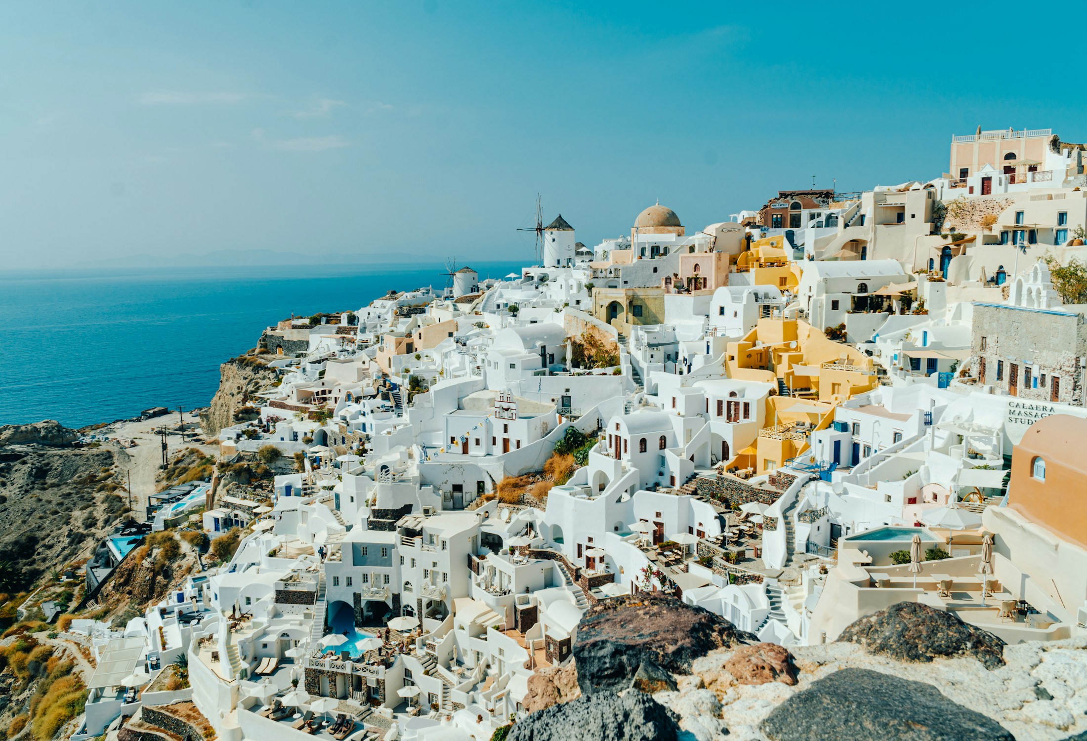Sunlit white houses and blue sea in Santorini